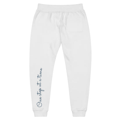 White sweatpants adorned with 'Walking by faith' text on back left leg.
