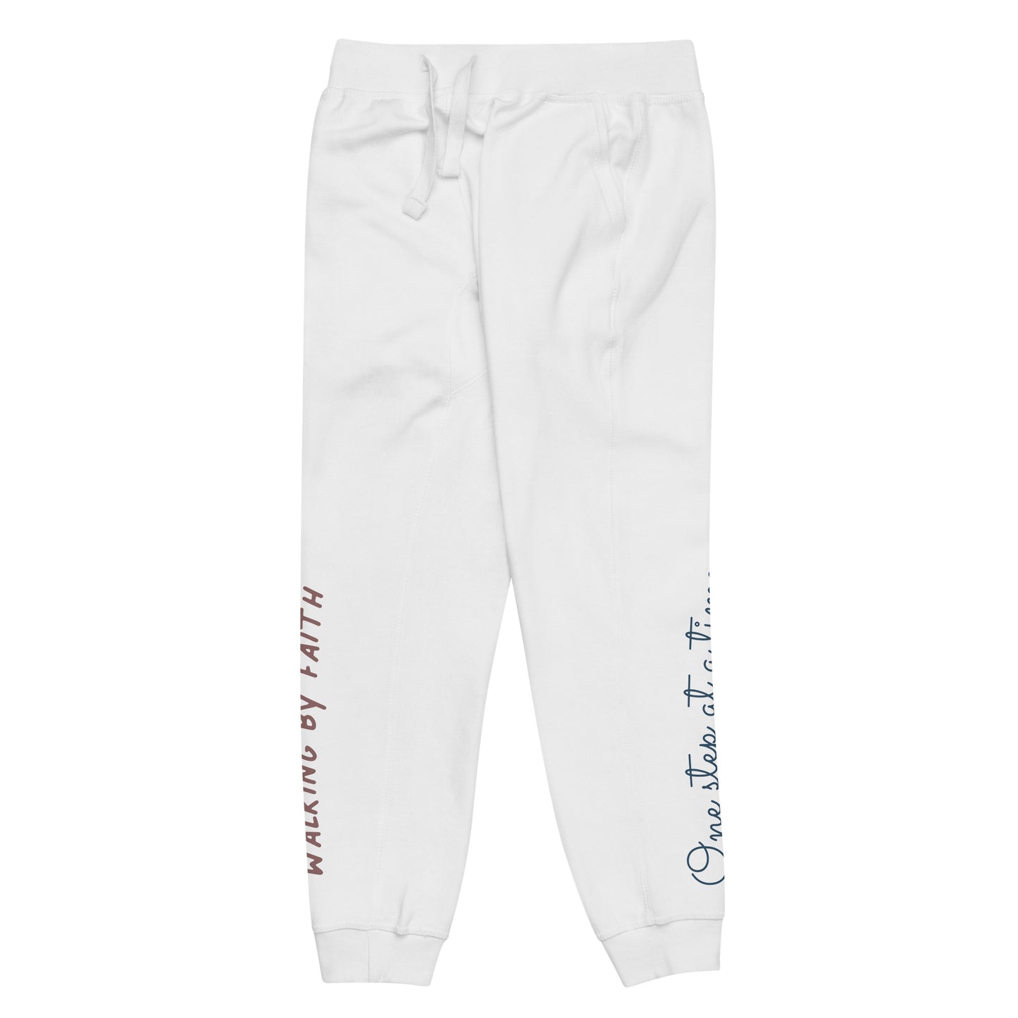 White sweatpants adorned with 'Walking by faith' text and eKuumeArt logo on front right leg and glimpse of 'One step at a time' on back left leg – side view.
