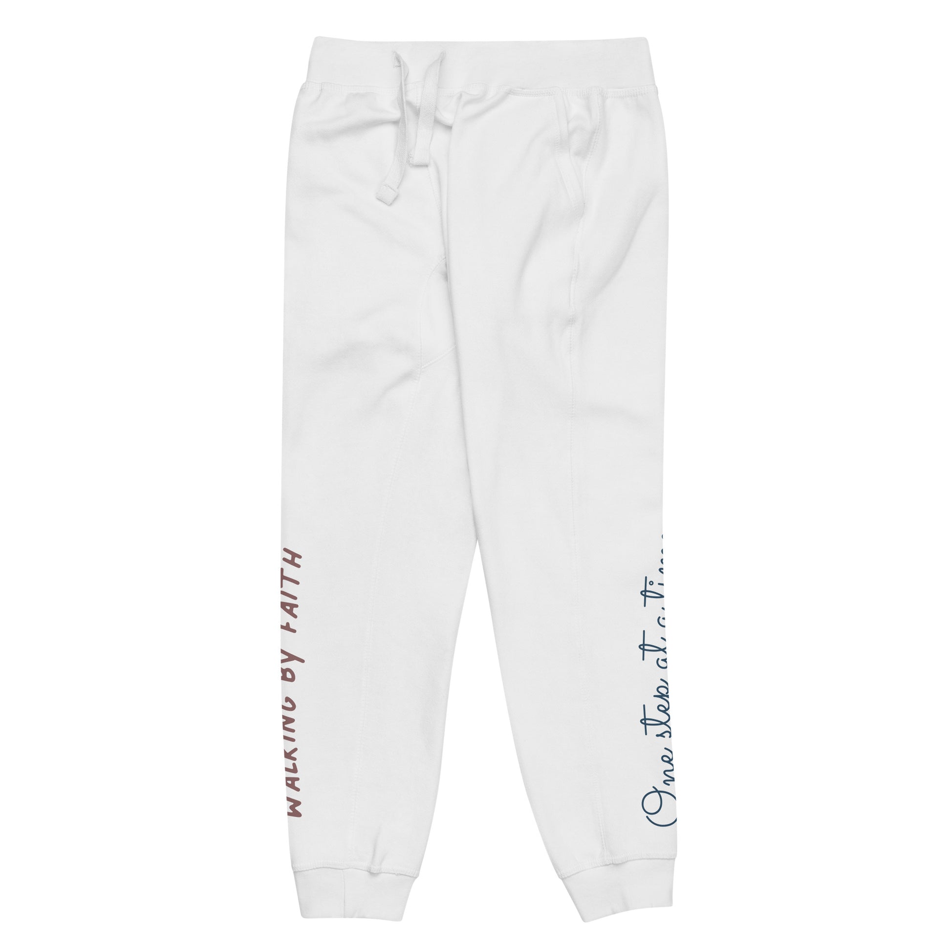 White sweatpants adorned with 'Walking by faith' text and eKuumeArt logo on front right leg and glimpse of 'One step at a time' on back left leg – side view.