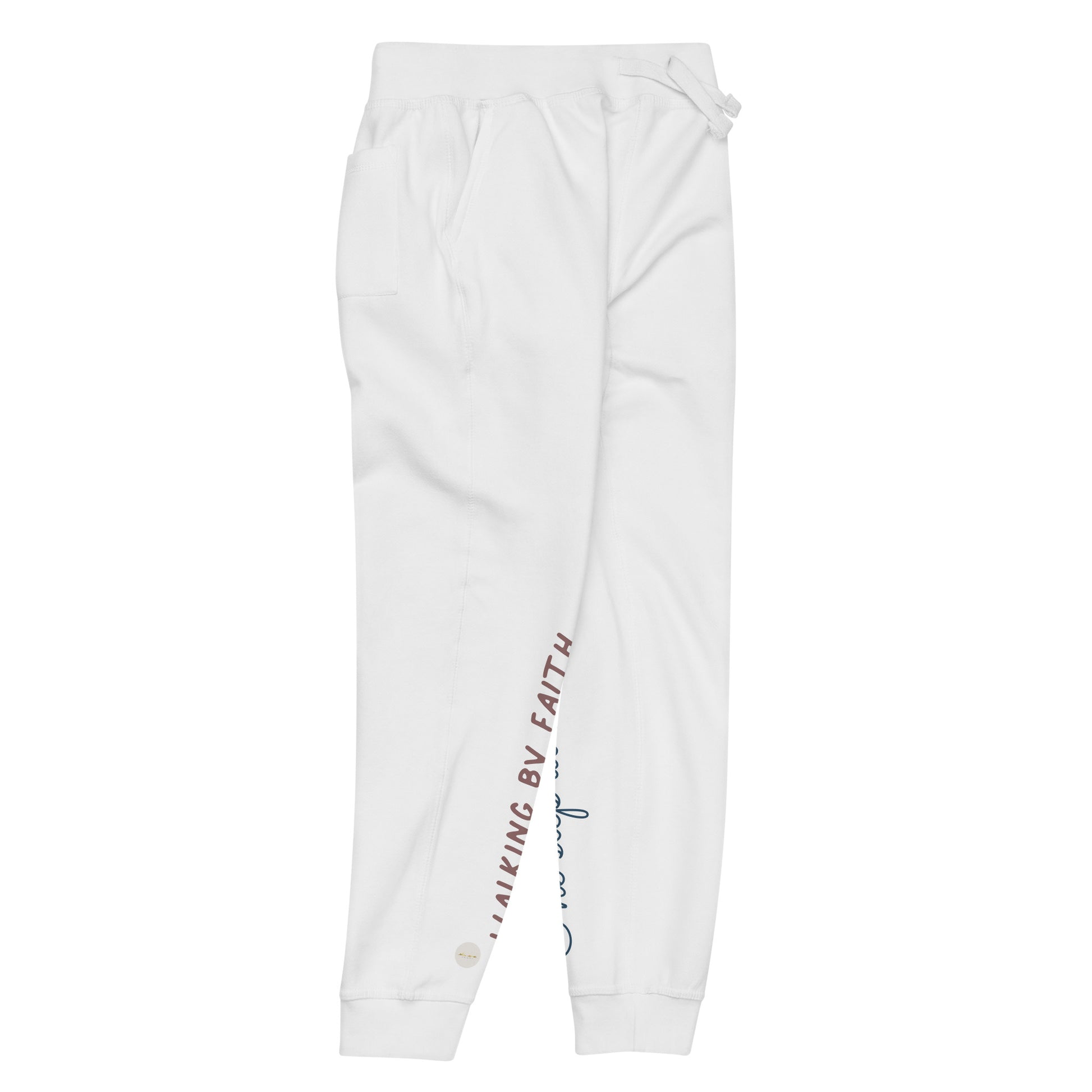 White sweatpants adorned with 'Walking by faith' text and eKuumeArt logo on front right leg and glimpse of 'One step at a time' on back left leg – side view.
