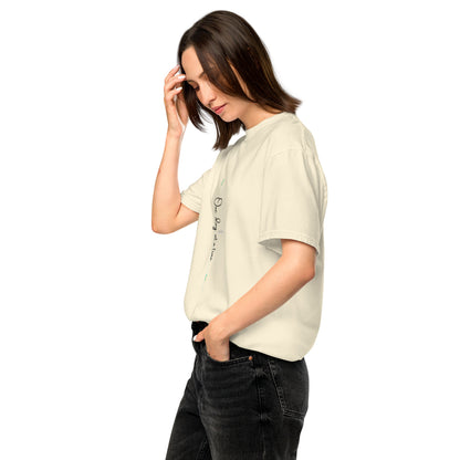 Woman wearing ivory tee with 'One day at a time' and eKuumeArt logo on middle chest – angled view.