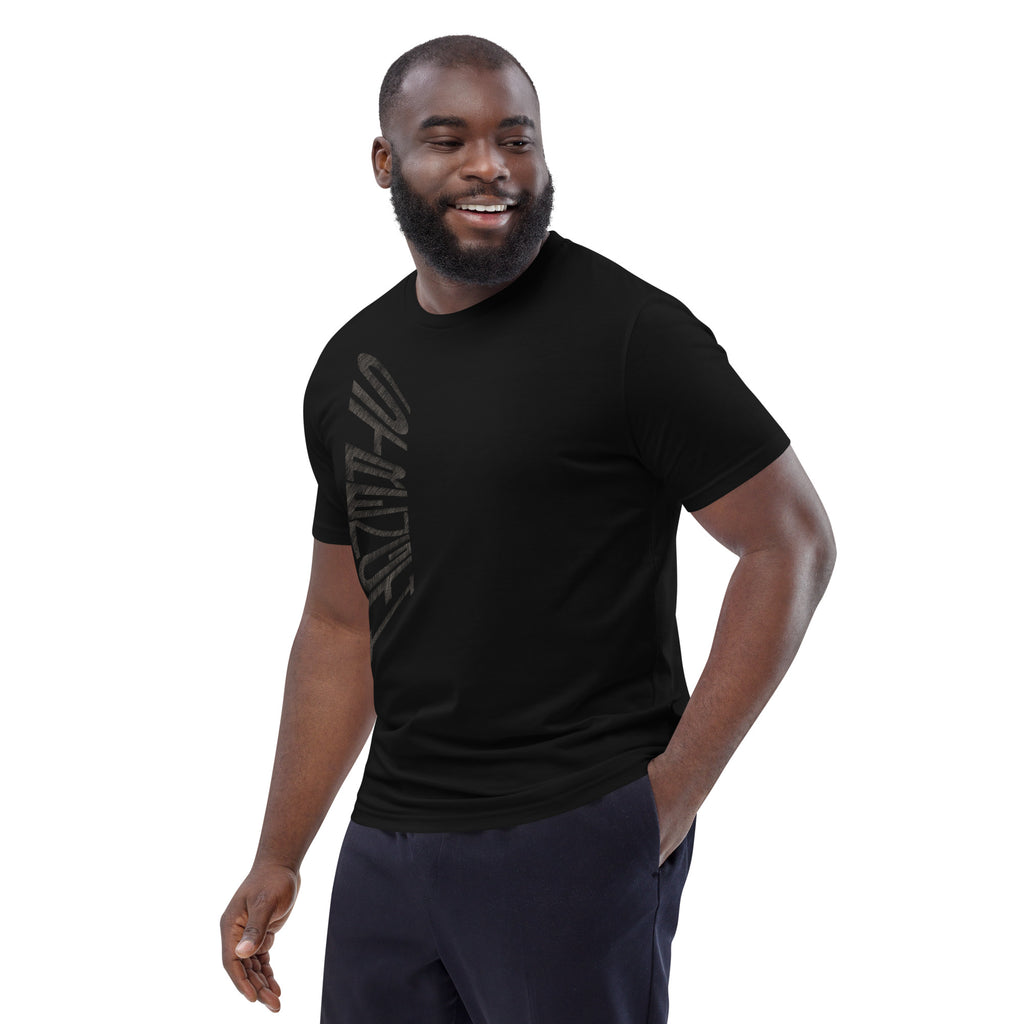 Man wearing black organic cotton t-shirt with hand-drawn 'Strength' text – angled view | eKuumeArt.