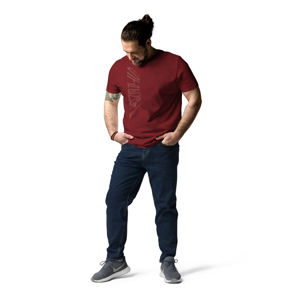 Man wearing burgundy organic cotton t-shirt with hand-drawn 'Strength' text and dark blue jeans | eKuumeArt.