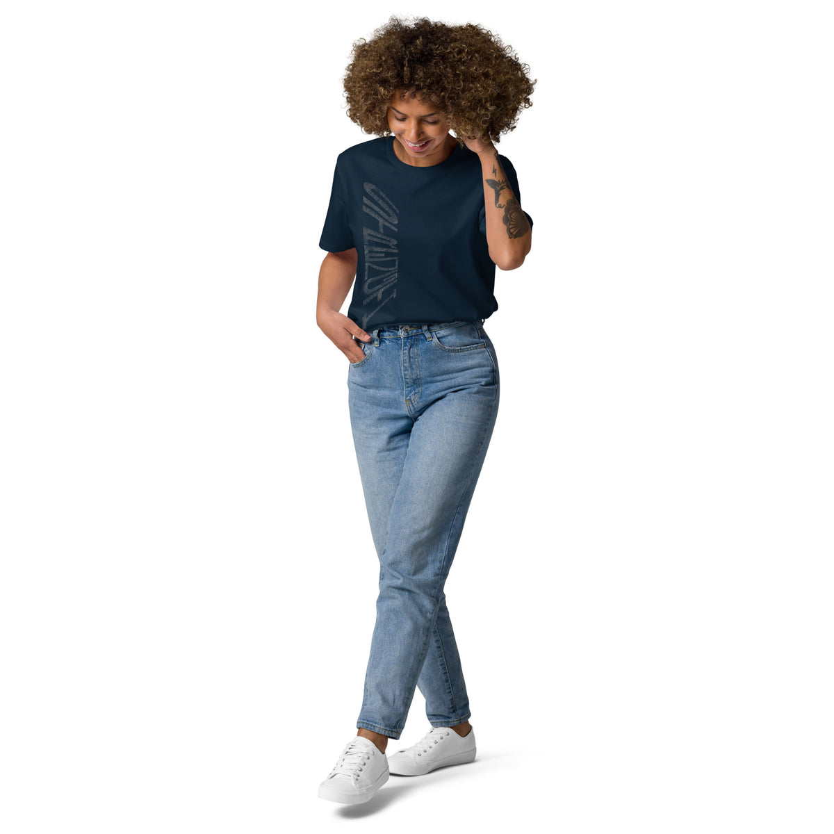 Lady wearing French navy organic cotton t-shirt with hand-drawn 'Strength' text and blue jeans | eKuumeArt.