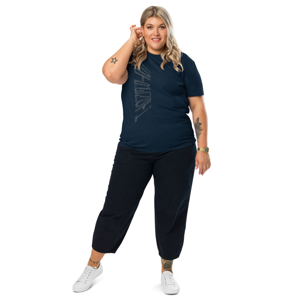 Woman wearing French navy organic cotton t-shirt with hand-drawn 'Strength' text, black trousers and white sneakers | eKuumeArt.