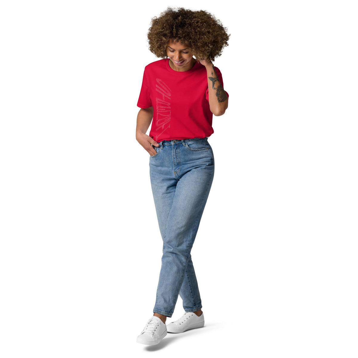 Lady wearing red organic cotton t-shirt with hand-drawn 'Strength' text and blue jeans | eKuumeArt.